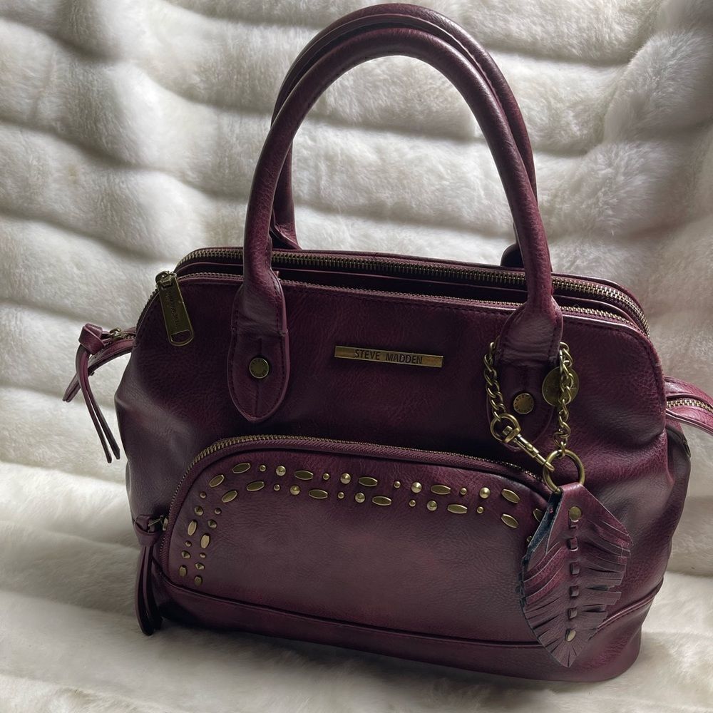 Steve Madden burgundy faux leather satchel with rustic studs accent.